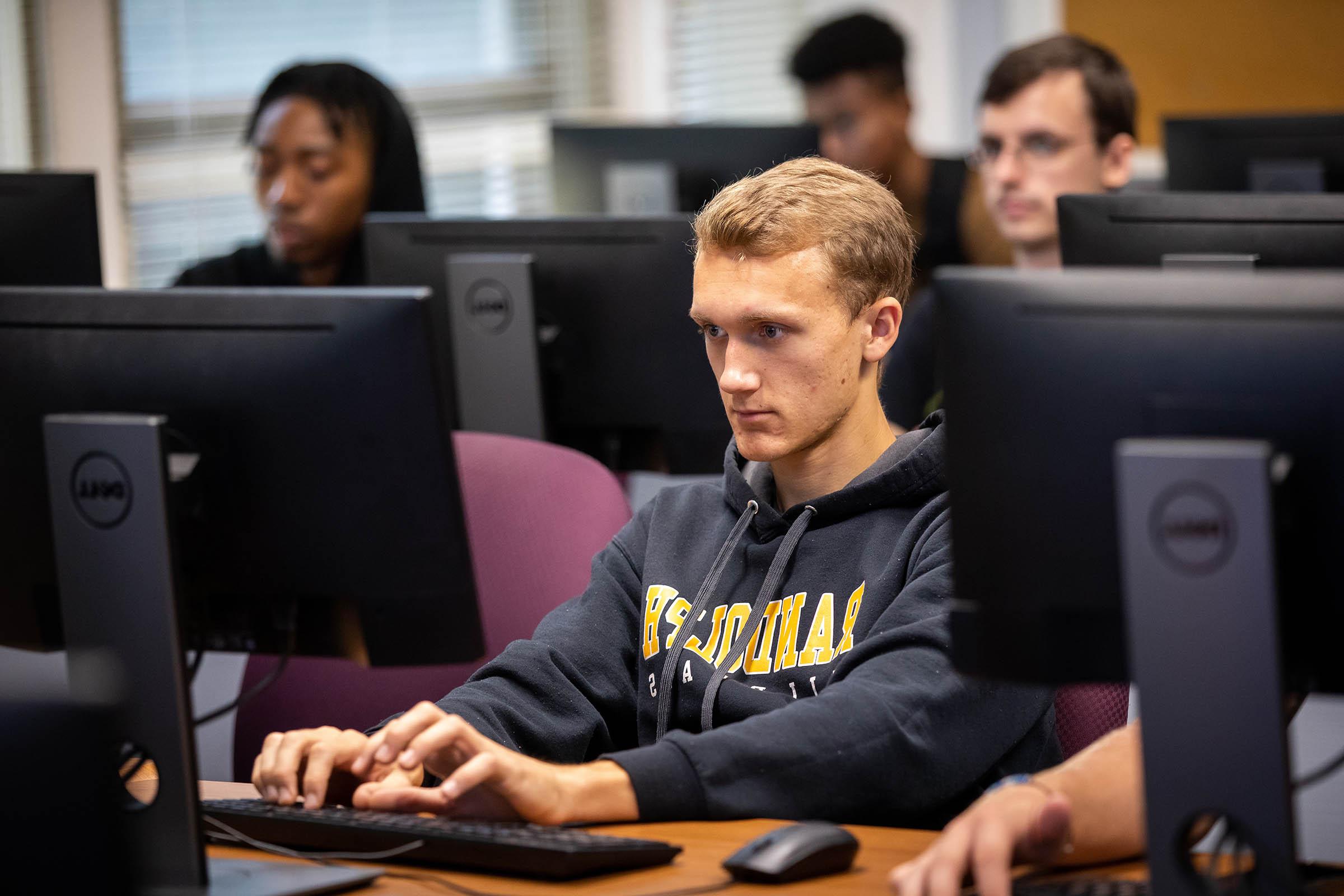 Randolph College students work on code in programming class.