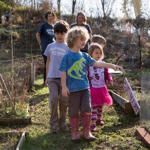 Students lead nursery school children on a nature walk through the College's Organic Garden.